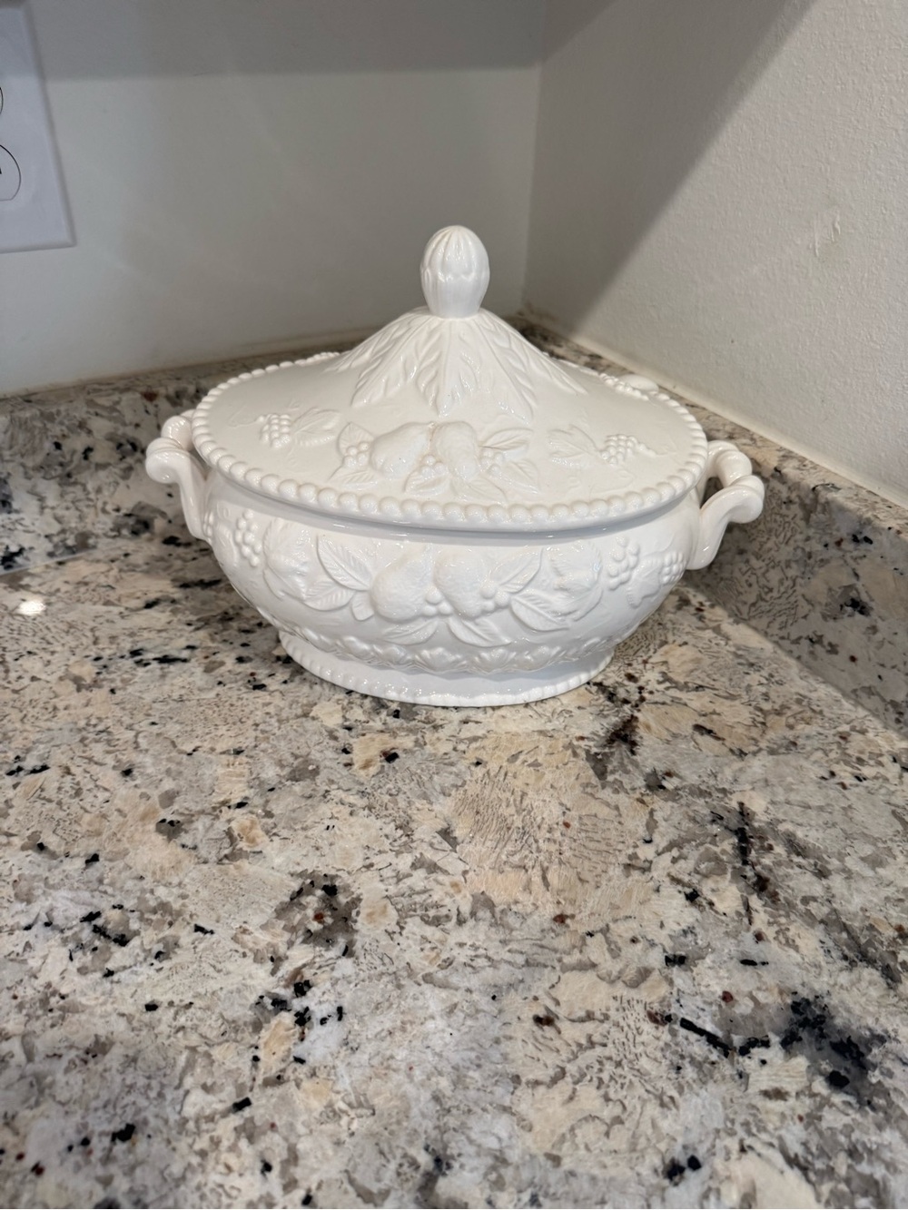 soup tureen with an embossed fruit and leaf design and ladle
